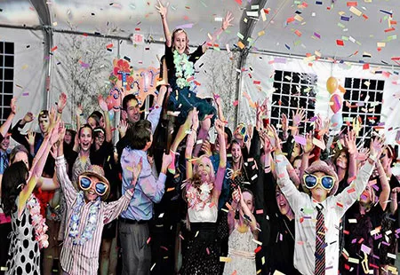 Colorful confetti falling on a group of a kids at a bat mitzvah