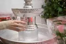 Woman filling up a cup from a beverage fountain