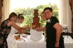 guests enjoying a chocolate fountain at a wedding