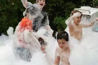 Kids playing in an outdoor foam party