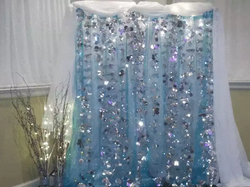 Blue, silver and white glitter lighted curtain for backdrop or photo area