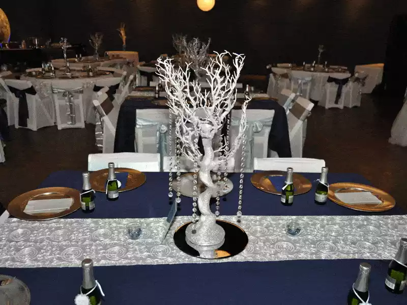 Silver manzanita centerpiece with crystal accents on glass plate
