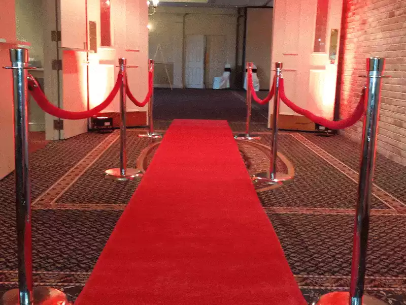Red carpet and uplighting at entrance to ballroom