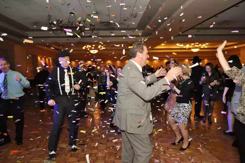 Confetti falling on dancers at a corporate party