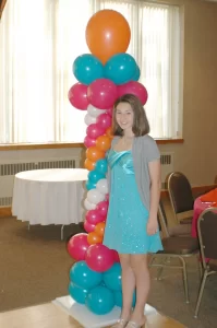 Girl standing in front of balloon tower