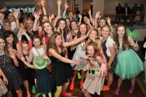 Group of kids posing for a picture while dancing at a PartyMasterz event