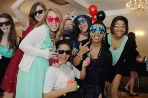 Girls wearing silly glasses posing for a photo at a bar mitzvah
