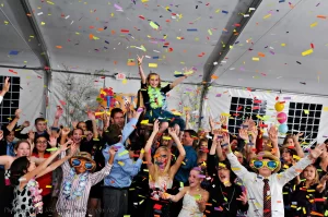 Chair lifting at a bat mitzvah during the hora while confetti is launched