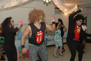 Guys dressed like LMFAO dancing at a Sweet 16 party