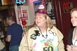 Woman dressed in 50th birthday hat and apron