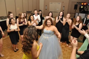 The sweet 16 dancing at her party as she is surrounded by friends