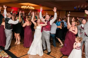 Bride and groom and wedding guests dancing
