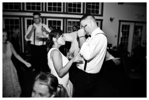 Black and white photo of bride and groom dancing on their wedding day