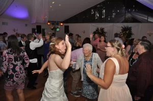 A bride and her family dancing at a wedding reception