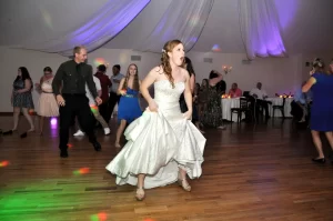 A bride doing a line dance at her wedding with friends