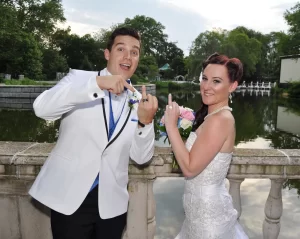 A bride and groom flipping their ring fingers