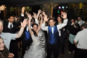 A wedding party group photo of people dancing