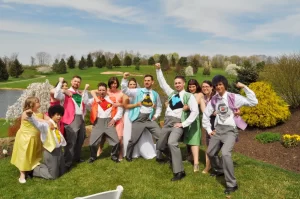 A wedding party showing off their super hero tshirts under their suits
