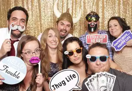 People posing in PartyMasterz photo booth