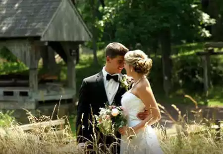 video Newlyweds in a field for photo on their wedding day