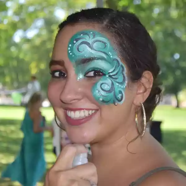 A woman with face paint on her face from a partymasterz event