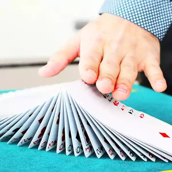 a hand moving a deck of cards like a magician