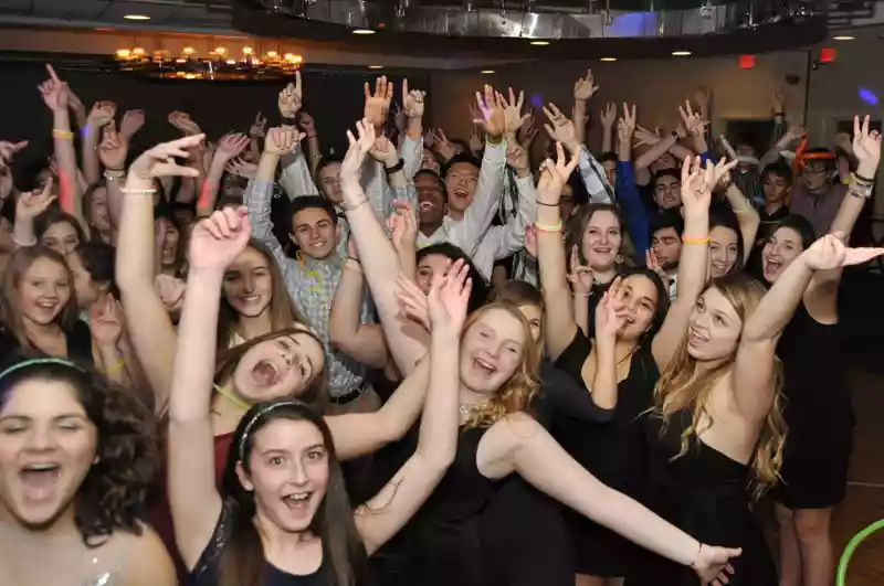 Large group of kids dancing at a party